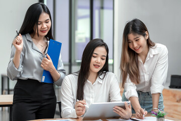 Group of beautiful young Asian businesswoman happily working together at the office.