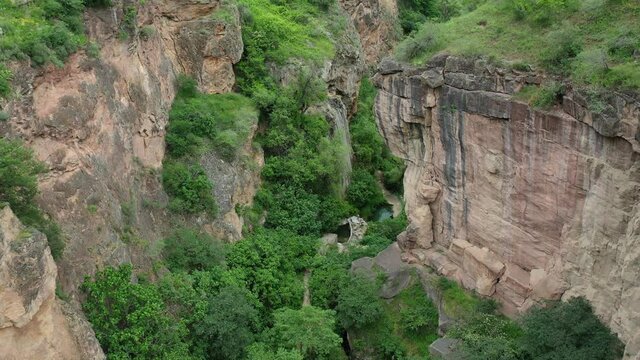   Devil bridge natural monument in the Syunik region of Armenia. Devils' bridge in Armenia, Caucasus,  Aerial view. Drone fly over Natural bridge and rocks. Famous touristic place in Armenia.