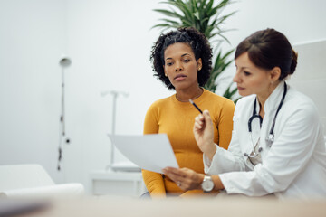 Doctor and patient in medical office, talking about treatment.