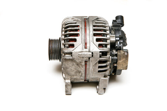 The old used and broken alternator from the motor vehicle isolated on a white background. 