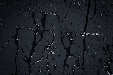 Fototapeta premium Water on dark stone surface