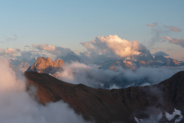 Mountains and mountain peaks surrounded by thick white clouds