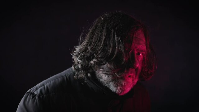 The disgusting bum turns to you. Dirty hair hangs down from his face. The tramp is dressed in black clothes. The man scares everyone with his appearance. The gesture runs along the neck.