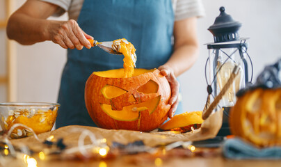 Senior woman is carving pumpkin