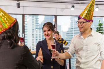 Group of diversity corporate colleagues celebrating new year and Christmas party together. Cheerful multicultural business people party, drinking and having fun together at workplace