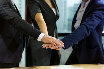 Group of business people putting their hands together in the office. Business people stack of hands together. Successful and teamwork concept