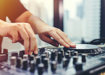 DJ mixing music on console at the club