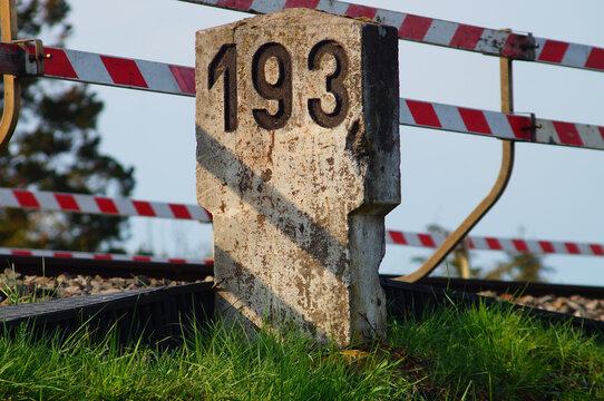 An old milestone on a railway line
