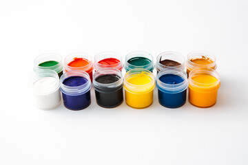 Open jars with gouache of different colors on white background.hobby painting . Learning to draw....