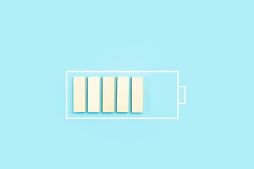 Load battery charge icon background. Wooden blocks as a charging process