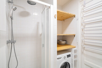 Small white bathroom interior with shower and washing machine