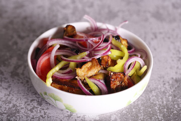 eggplant tomato pepper and onion salad is on the table