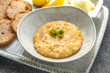 Pike caviar, butter with crispy croutons and lemon appetizer. Ready menu for the restaurant. Neutral gray blue textured background
