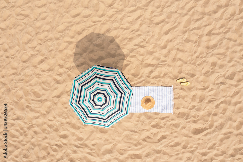 Canvas Prints Beach umbrella near towel and other vacationist's stuff on sand, aerial view