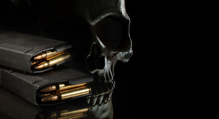 Human skull on a dark background with 30 round magazines for an AR-15 with copy space