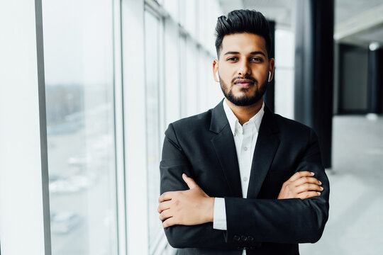 Portrait of a handsome serious Indian man, Asian appearance, office worker,  bank employee, modern building Stock Photo | Adobe Stock