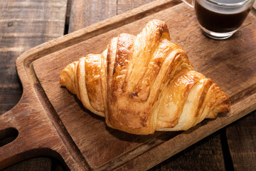 breakfast food coffee and croissant on isolated wood table.
