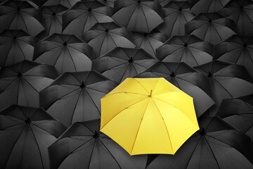 Yellow umbrella standing out of other ones, above view © New Africa
