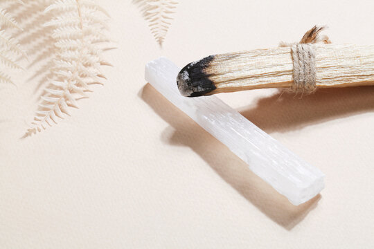 Palo Santo stick, selenite on beige background