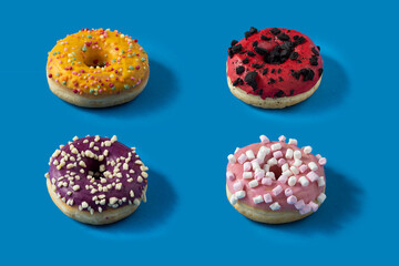 Different type donuts on blue background for menu