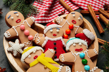 Delicious Christmas cookies and fir branches on black table, closeup