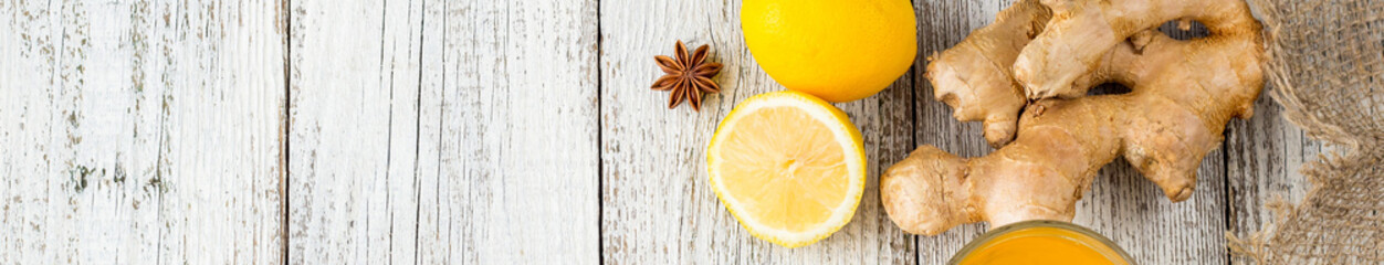banner of Autumn hot drink tea with ginger, lemon, honey and spices on white wooden background
