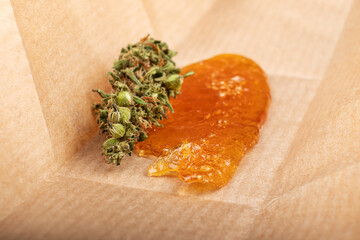 dried cannabis bud with concentrate wax oil closeup.