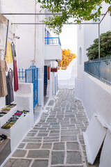 Ios Nios island, Chora village, Cyclades Greece. Souvenir shops empty paved alley. Vertical