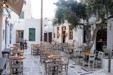 Traditional outdoor cafe bar at cobblestone yard at Ios Nios island Chora Cyclades Greece.