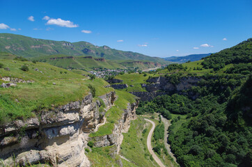 Fototapeta na wymiar Above of Tyzyl Gorge. Beautiful view of the mountainous landscape and valley of river at sunny day. Nature and travel. Russia, Caucasus, Kabardino-Balkaria