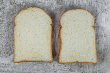 White bread slice isolated on wood background