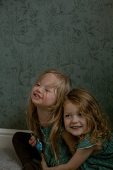 Twin girls with Down Syndrome hugging each other and smiling