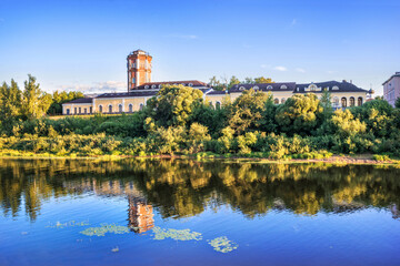 Fototapeta premium Water tower and reflection in the river in Vologda in the light of a summer evening