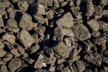 Pale black coal, close-up, heating season, coal industry.