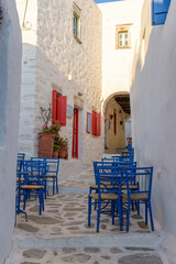 Traditional cycladitic   alley with a  whitewashed  facades and an exterior of a cafe  in chora Amorgos  Greece