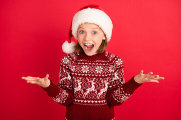 Portrait of attractive amazed cheerful girl having fun eve newyear festal good mood isolated over bright red color background