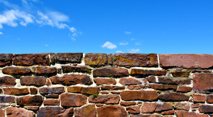 Old stone wall and blue sky