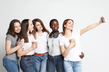 Obraz premium Diverse multi nation female group, african-american and caucasian teenage friends company make selfie