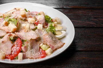Delicious fresh salad with bacon and tomatoes with spices and greens