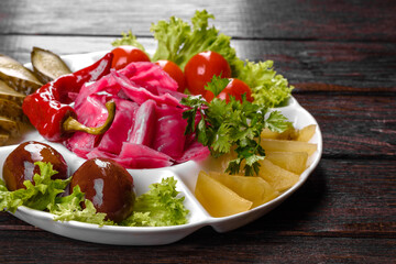 Delicious spicy pickles cut on a serving plate