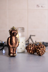 festive image with a Christmas garland, a toy and pine cones