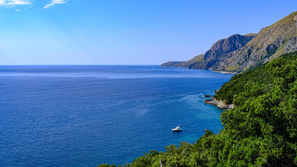 Cilento coast, Scario. Campania, Italy. View of the azure sea, coast and boat.