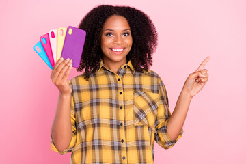 Photo of reliable lady hold fan phone case direct finger empty space wear plaid shirt isolated pink...