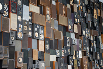 Collection of many vintage loudspeakers on a wall. Retro interior music sound box. Nostalgia music...