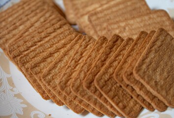 wheat biscuits also called food cracker famous as chai biscuit in india and pakistan served with tea mostly displayed in plate with blurry background, selective focus