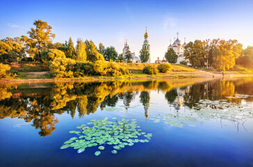 Kremlin temples and water lilies in the river in Vologda in the light of a summer evening
