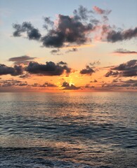 Beautiful sunset or sunrise above the sea or ocean. Vertical image