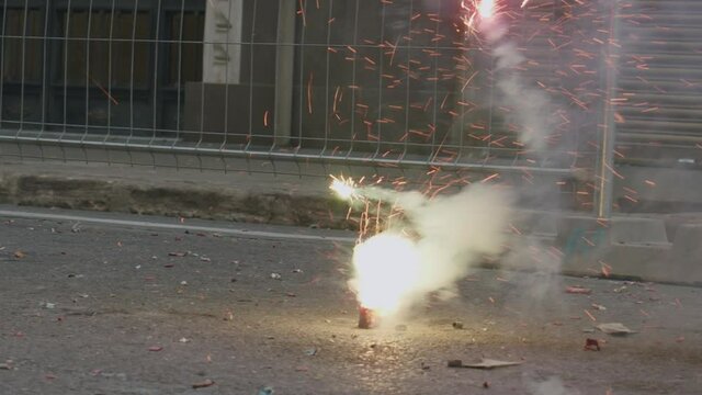Firecracker bursting in the street. Las Fallas celebration, Spain