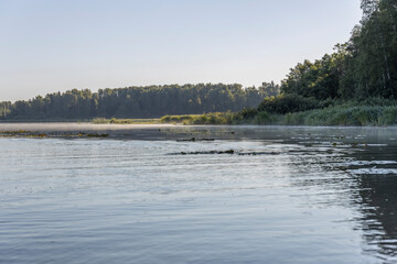 Summer landscape with a river. Early morning. Beautiful sunrise on the river.