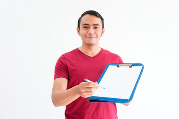 young man handing a table with a sheet of paper and pen to write down, on a white background